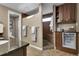 Bathroom with granite countertops, mini fridge, and tiled walk-in shower at 4220 S Yarrow Ct, Lakewood, CO 80235