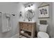 Charming bathroom with a rustic vanity, gold fixtures, and modern lighting at 4220 S Yarrow Ct, Lakewood, CO 80235