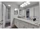 Well-lit bathroom featuring double sinks, granite countertops, and modern fixtures at 4220 S Yarrow Ct, Lakewood, CO 80235