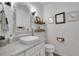 Stylish bathroom featuring a vessel sink, decorative mirror, and neutral decor at 4220 S Yarrow Ct, Lakewood, CO 80235