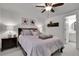 Charming bedroom featuring a ceiling fan, decor, and an ensuite bathroom at 4220 S Yarrow Ct, Lakewood, CO 80235