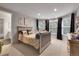Bedroom with a large window, stylish decor, and access to an en-suite bathroom at 4220 S Yarrow Ct, Lakewood, CO 80235