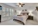 Bright bedroom with neutral decor, shutters on the windows, and a comfortable bed with side tables at 4220 S Yarrow Ct, Lakewood, CO 80235