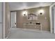Hallway with neutral walls, stylish lighting fixtures, and a console table with decor at 4220 S Yarrow Ct, Lakewood, CO 80235