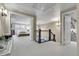 Open hallway that leads to a bedroom and staircase with natural light at 4220 S Yarrow Ct, Lakewood, CO 80235