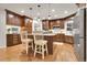 Gourmet kitchen featuring custom cabinetry, quartz countertops, a large island, and stainless steel appliances at 4220 S Yarrow Ct, Lakewood, CO 80235