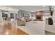 Open-concept living area with brick fireplace and an adjacent dining area with hardwood floors at 4220 S Yarrow Ct, Lakewood, CO 80235
