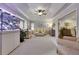 Bright living room featuring tray ceilings, a large aquarium, neutral carpeting and furnishings, and white shutters at 4220 S Yarrow Ct, Lakewood, CO 80235