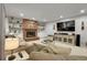 Inviting living room featuring a brick fireplace, built-in shelving, and comfortable seating at 4220 S Yarrow Ct, Lakewood, CO 80235