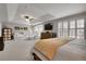 Spacious main bedroom with sitting area, shutters, ceiling fan, and large windows at 4220 S Yarrow Ct, Lakewood, CO 80235