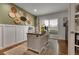 Cozy home office with custom desk, hardwood floors, white plantation shutters, and decorative wall art at 4220 S Yarrow Ct, Lakewood, CO 80235