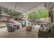 Relaxing outdoor patio featuring comfortable seating, a stone pathway, and a beautifully landscaped yard at 4220 S Yarrow Ct, Lakewood, CO 80235
