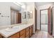 Bathroom with double sinks, light wood cabinetry, and a separate shower/toilet room at 7474 E Arkansas Ave # 17-07, Denver, CO 80231