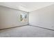 Bright bedroom with neutral walls, plush carpeting, and a large window for natural light at 7474 E Arkansas Ave # 17-07, Denver, CO 80231