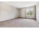 Bright bedroom with neutral carpet, light gray walls, and natural light at 7474 E Arkansas Ave # 17-07, Denver, CO 80231
