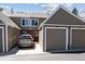 Exterior view of townhome with attached garage, driveway and lush landscaping at 7474 E Arkansas Ave # 17-07, Denver, CO 80231