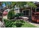 Exterior view of townhome with mature trees, backyard deck and patio at 7474 E Arkansas Ave # 17-07, Denver, CO 80231
