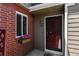 A charming brick-accented front entrance with a decorative security door and flower box at 7474 E Arkansas Ave # 17-07, Denver, CO 80231