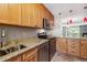 Modern kitchen with stainless steel appliances, granite countertops, and bright lighting at 7474 E Arkansas Ave # 17-07, Denver, CO 80231