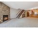 Spacious living room with a stone fireplace and staircase at 7474 E Arkansas Ave # 17-07, Denver, CO 80231