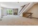 Spacious living room with stone fireplace, plush carpeting, and access to outdoor area at 7474 E Arkansas Ave # 17-07, Denver, CO 80231