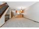 Open-concept living room featuring gray carpet and bar seating area to the kitchen at 7474 E Arkansas Ave # 17-07, Denver, CO 80231