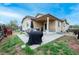 Enjoy a backyard featuring a patio, outdoor grill, dining and seating furniture, and grass at 9844 Norfolk St, Commerce City, CO 80022