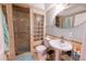 Bathroom with a shower stall and glass block window at 9844 Norfolk St, Commerce City, CO 80022