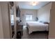 Bedroom featuring neutral walls, blinds on the window, and dresser at 9844 Norfolk St, Commerce City, CO 80022
