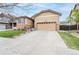 Charming single-Gathering home featuring stone accents, a two-car garage, and a well-maintained front yard at 9844 Norfolk St, Commerce City, CO 80022