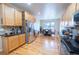 Spacious kitchen featuring stainless steel appliances, granite countertops, and hardwood floors at 9844 Norfolk St, Commerce City, CO 80022