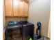 Laundry room featuring a washer, dryer, wood cabinets and cleaning supplies at 9844 Norfolk St, Commerce City, CO 80022