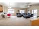 Spacious living room featuring high ceilings, carpeted floors, and a comfortable seating area at 9844 Norfolk St, Commerce City, CO 80022