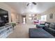 Large living room with neutral carpet, vaulted ceilings, and a view into the entry and dining area at 9844 Norfolk St, Commerce City, CO 80022