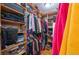 Walk-in closet features custom built-in shelving for shoes and hanging clothes at 9844 Norfolk St, Commerce City, CO 80022