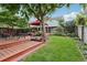 Inviting backyard featuring a cozy gazebo, lush landscaping, and a well-maintained lawn at 742 Mockingbird Ln, Brighton, CO 80601