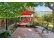 Charming backyard with a brick patio, bench seating, and a gazebo providing shade at 742 Mockingbird Ln, Brighton, CO 80601