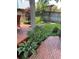 Backyard patio featuring ample seating, a wooden deck, a red maple tree, and a well-manicured garden at 742 Mockingbird Ln, Brighton, CO 80601