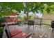 Inviting backyard deck with seating, mature trees and a red gazebo, perfect for entertaining at 742 Mockingbird Ln, Brighton, CO 80601