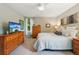 Bright bedroom with a full size bed, natural light, and wooden furnishings at 742 Mockingbird Ln, Brighton, CO 80601