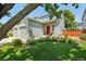 Charming home featuring a well-manicured lawn, gray siding, and a vibrant red front door at 742 Mockingbird Ln, Brighton, CO 80601