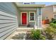 Inviting front entrance boasts a vibrant red door and well-maintained landscaping for a warm welcome at 742 Mockingbird Ln, Brighton, CO 80601
