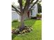 Charming home with a gray exterior, complemented by a vibrant red door and a lush, landscaped front yard at 742 Mockingbird Ln, Brighton, CO 80601