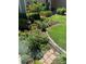 Well-manicured front yard with lush greenery, a colorful flower bed, and manicured hedges, enhancing curb appeal at 742 Mockingbird Ln, Brighton, CO 80601