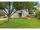Beautiful home with a large front yard, mature trees, and a well-kept lawn at 742 Mockingbird Ln, Brighton, CO 80601