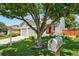 Inviting home with a manicured lawn, mature tree, and charming mailbox at 742 Mockingbird Ln, Brighton, CO 80601