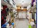 Organized garage with overhead storage racks, painted floors and ample space at 742 Mockingbird Ln, Brighton, CO 80601