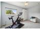 Home gym featuring an exercise bike, ceiling fan and natural lighting at 742 Mockingbird Ln, Brighton, CO 80601