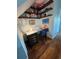 Cozy home office with built-in shelves, hardwood floors, desk, rolling chair, and natural light from nearby windows at 742 Mockingbird Ln, Brighton, CO 80601