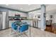 Kitchen with stainless appliances, breakfast nook, and pass-through window to the living area at 742 Mockingbird Ln, Brighton, CO 80601